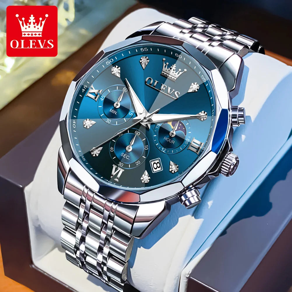 Silver watch with blue face on a white stand, OLEVS brand visible