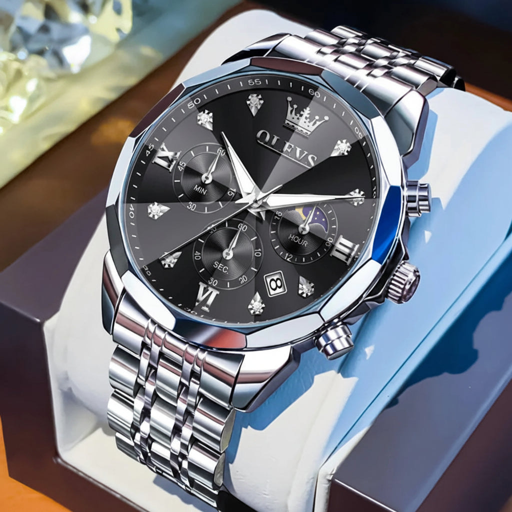 Silver watch with black dial on a white stand, OLEVS brand visible