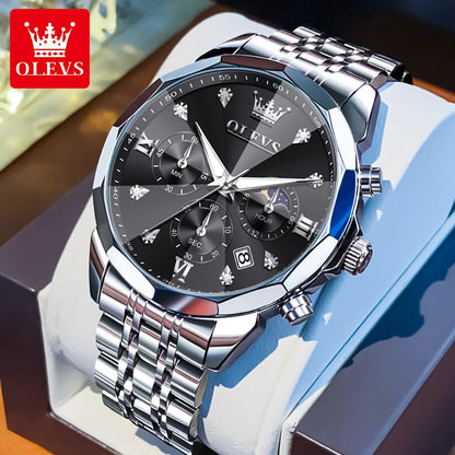 Silver watch with black dial on a white stand, OLEVS brand visible