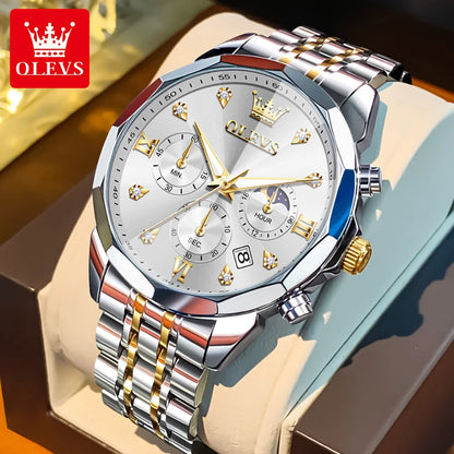 Silver and gold watch with detailed face and OLEVS branding on a brown surface.
