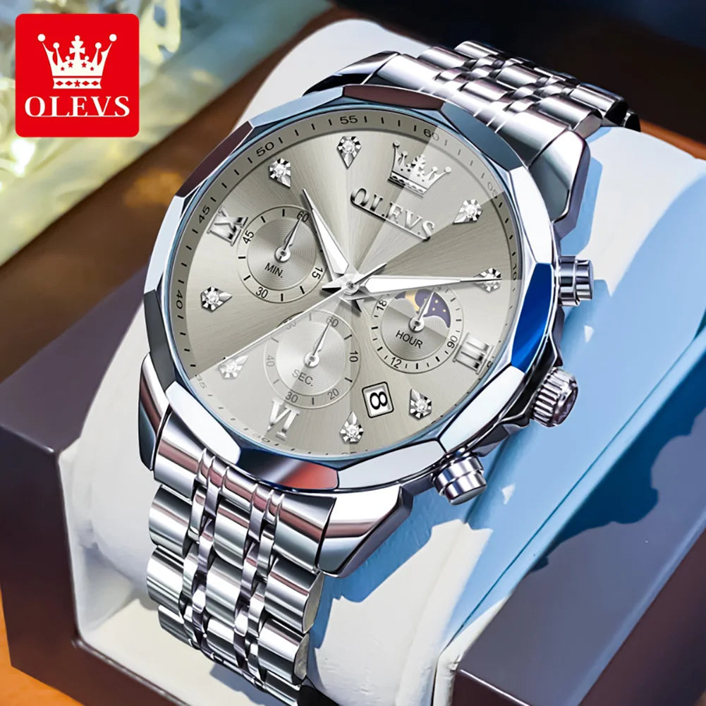 Silver OLEVS watch with detailed face on a blue cushion