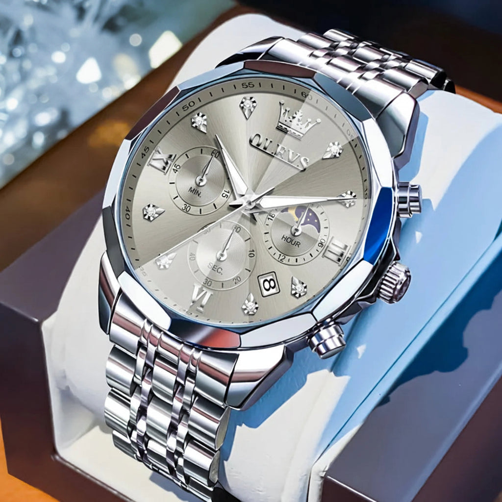 Silver OLEVS watch with detailed face on a blue cushion