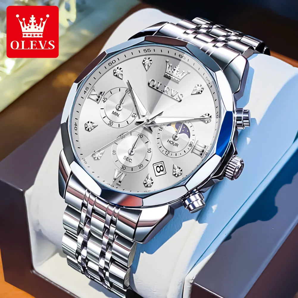 Silver watch with detailed face on a white stand, OLEVS brand visible